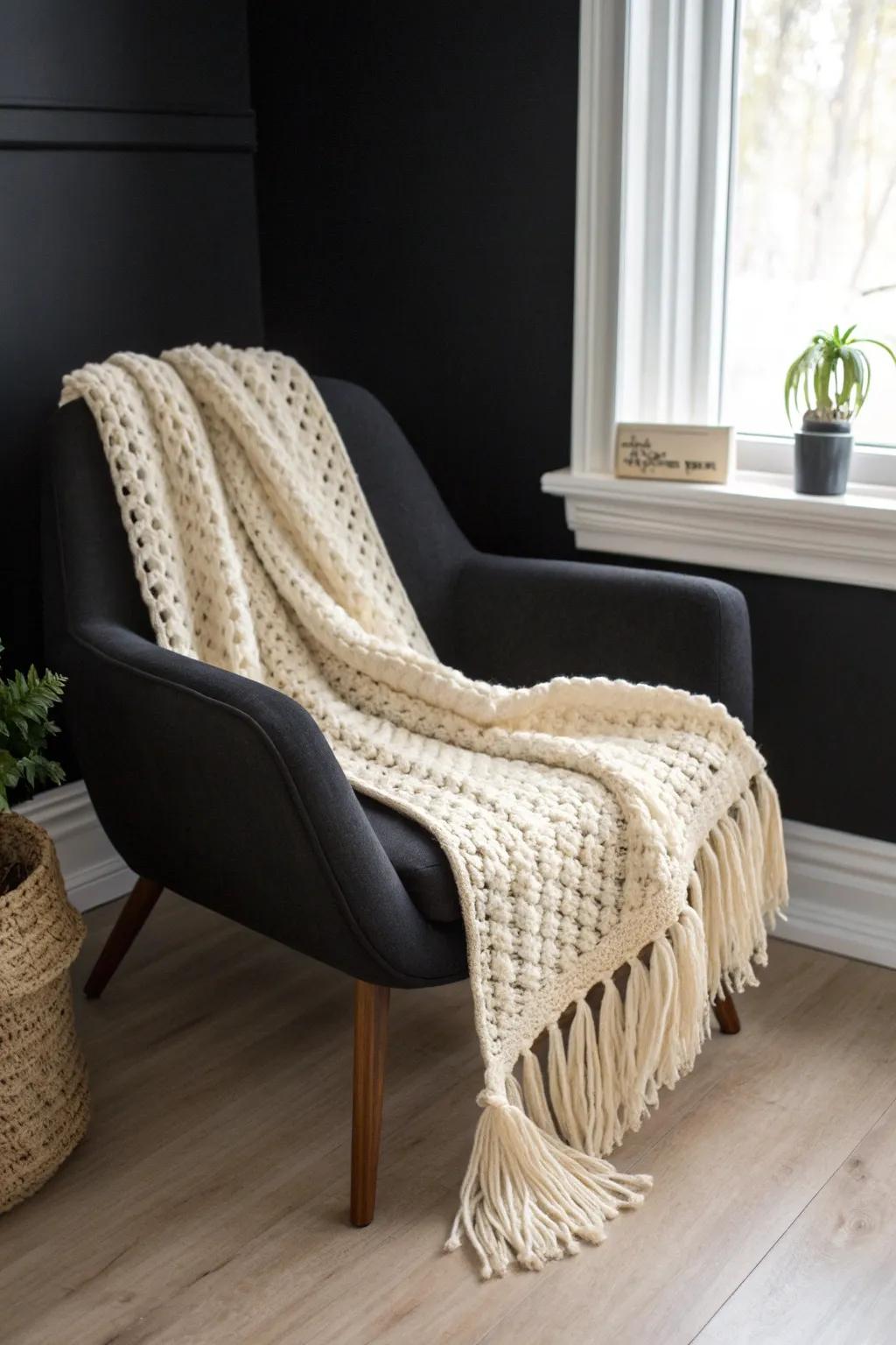 Cream throws and white pillows instantly brighten black rooms—easy contrast for small spaces.