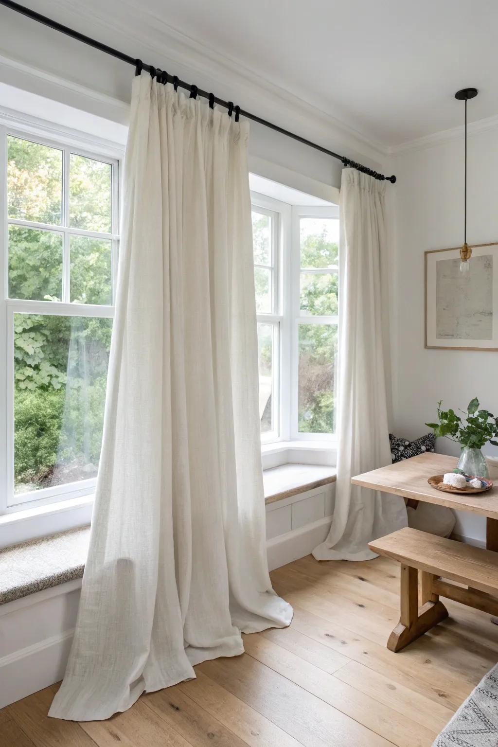 Four-panel waterfall curtains make a corner window feel lush, intentional, and beautifully styled.
