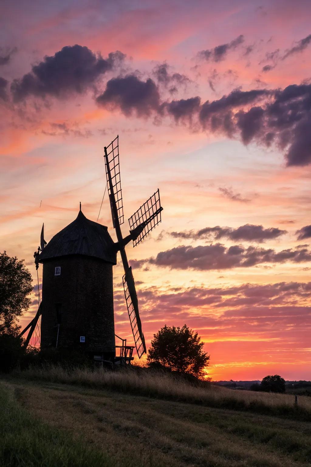 Capturing the serene elegance of a windmill at sunset, where simplicity meets the beauty of nature.
