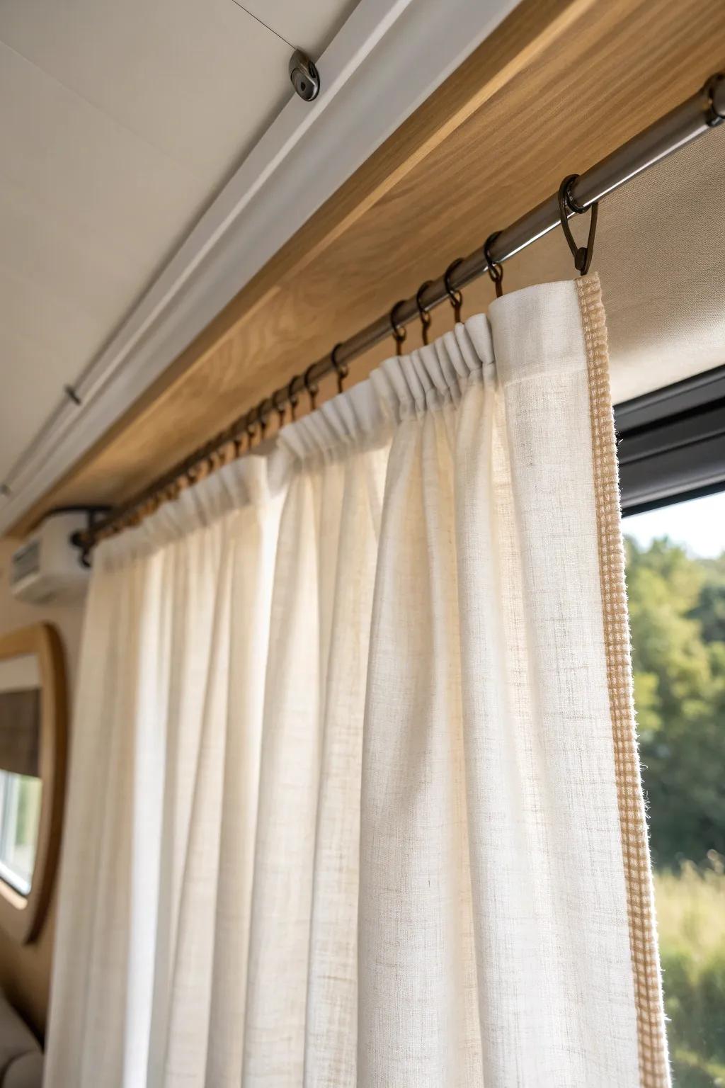 Ceiling-mounted linen curtains draw the eye up—an easy trick to fake taller camper windows.