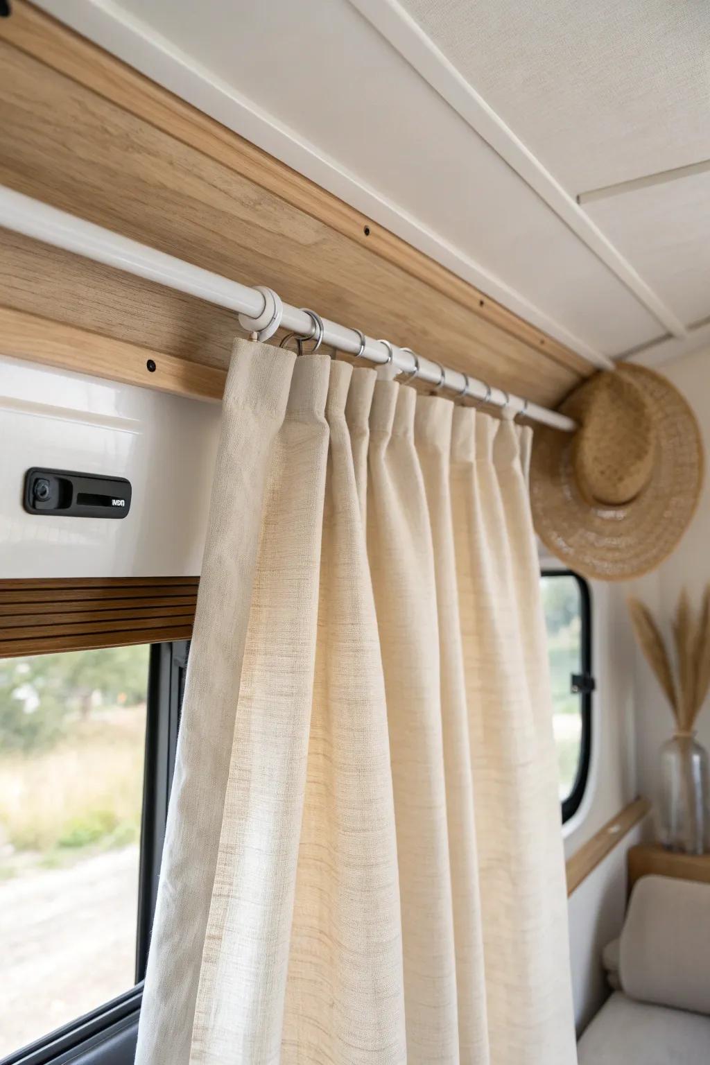 Ceiling-track linen curtains create flexible zones—privacy without bulk in a toy hauler.