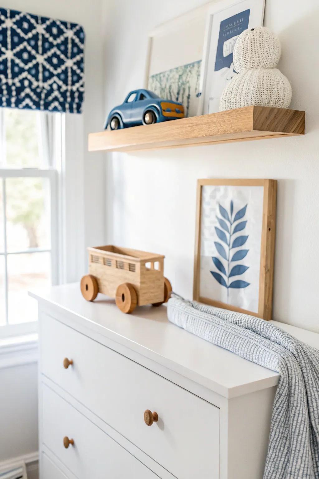 Floating shelf above the dresser adds storage without clutter—perfect for a small baby boy nursery.