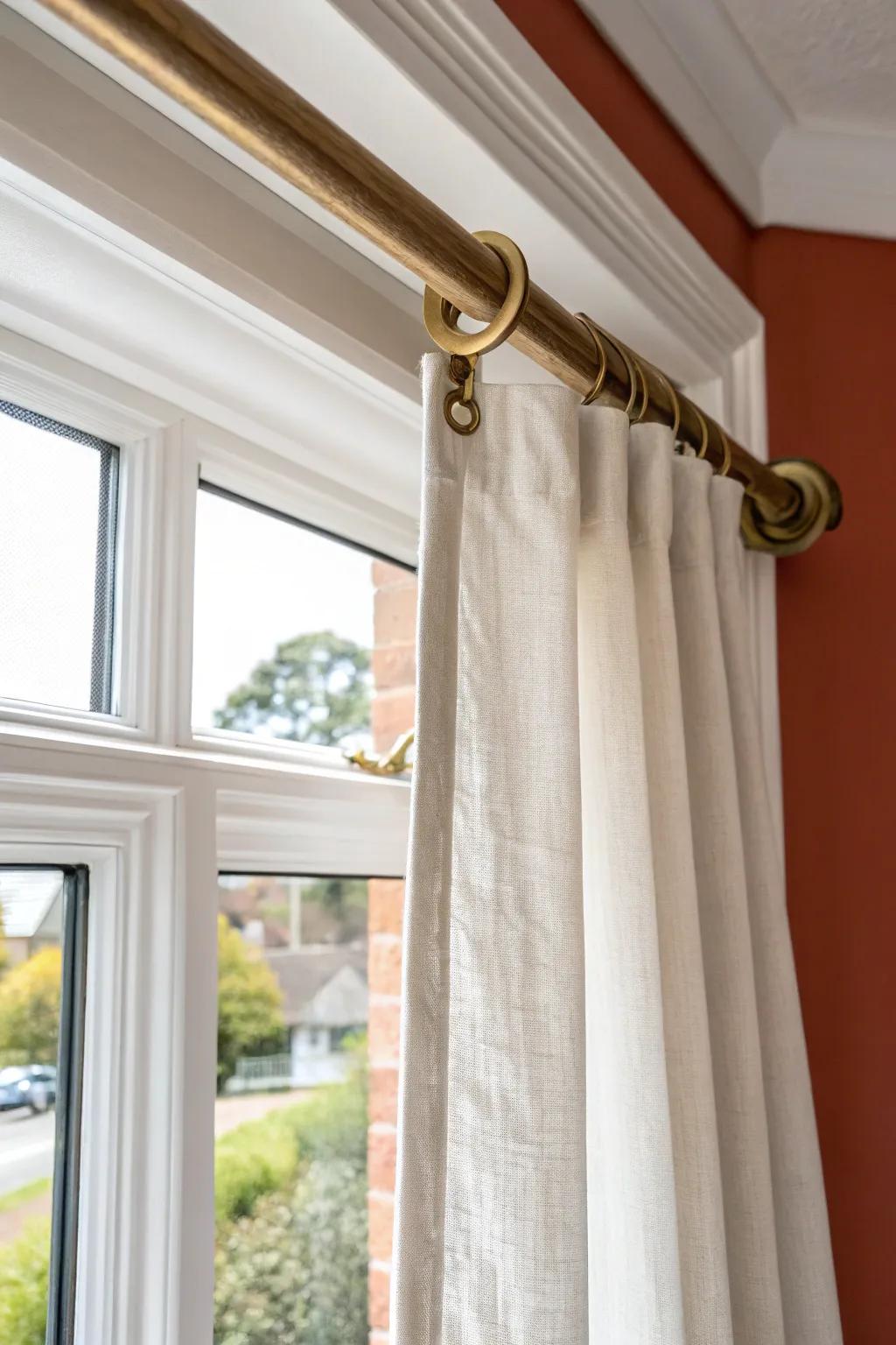 An angled rod inside the bay keeps curtains close to the glass for sleek, custom privacy.