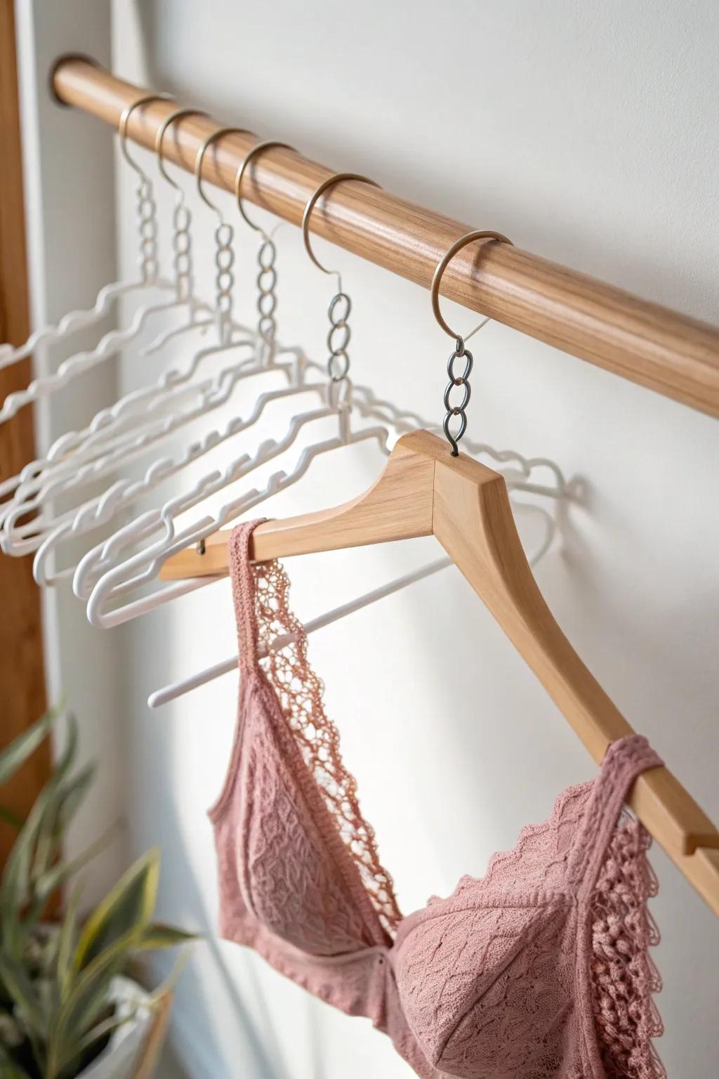 Save closet rod space with a chic vertical hanger chain for bras—pretty, minimal, and smart.