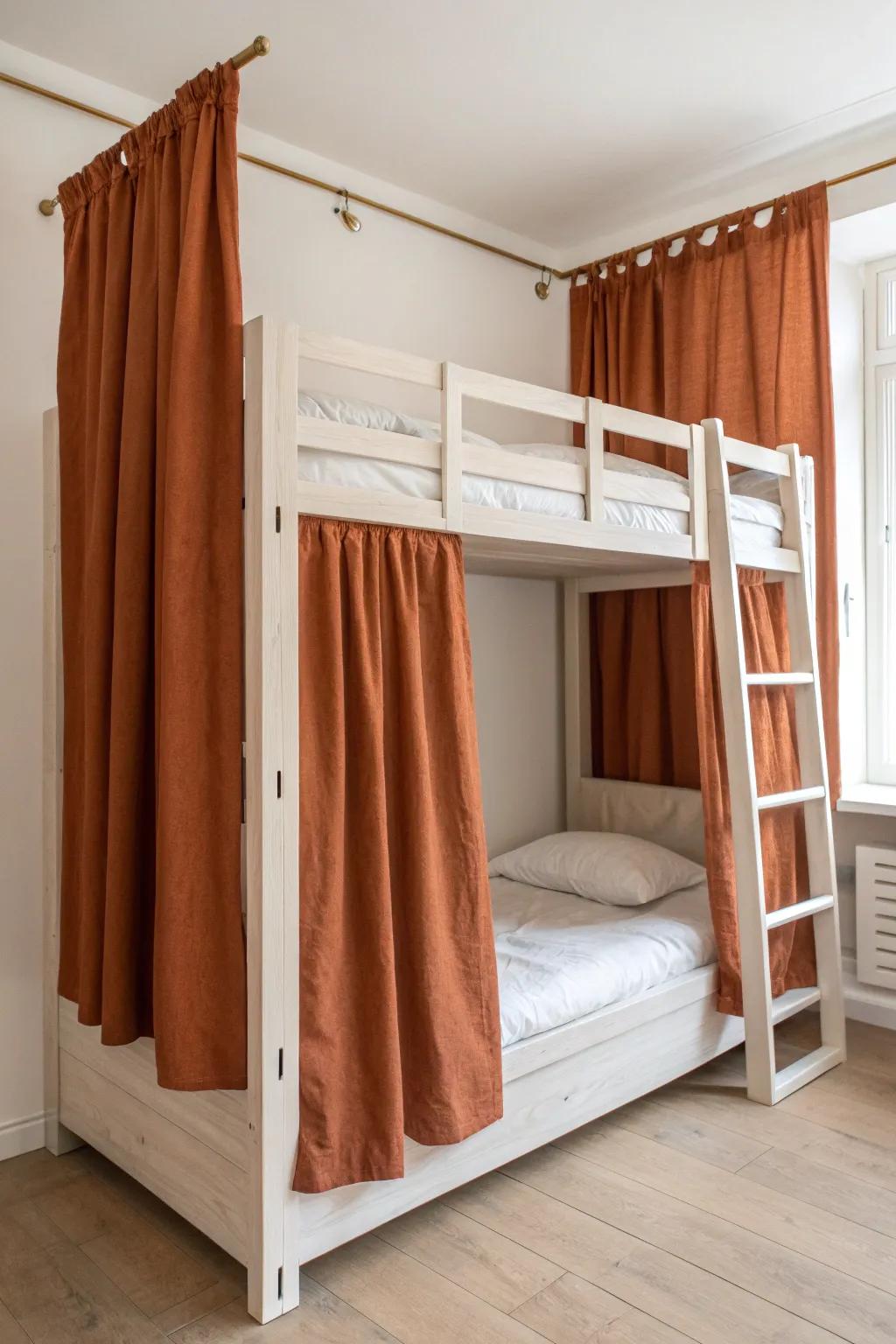 Add linen privacy curtains to a minimalist bunk bed for two calm, cozy mini-suites in small spaces.