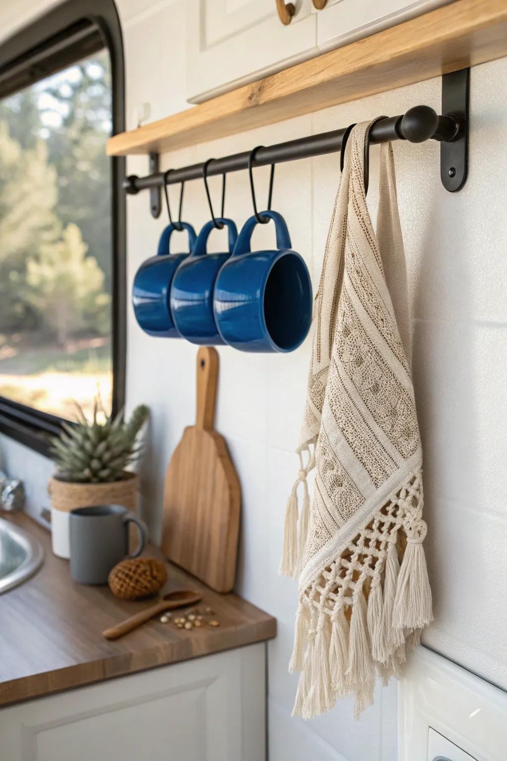 A chic RV wall rail that doubles as decor—mugs, hooks, and a boho towel in one spot.