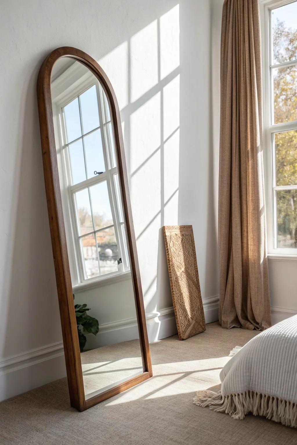 Lean a full-length mirror by the window to bounce daylight and instantly widen your bedroom.