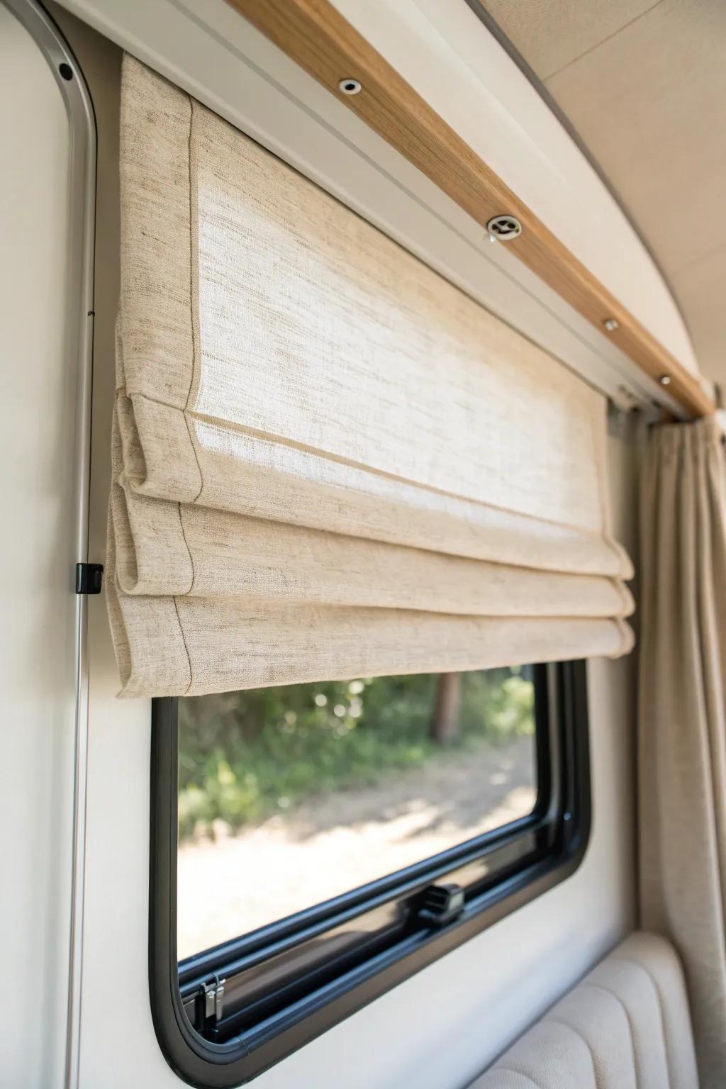 Soft linen Roman shade folds instantly make a tiny RV window feel like home.
