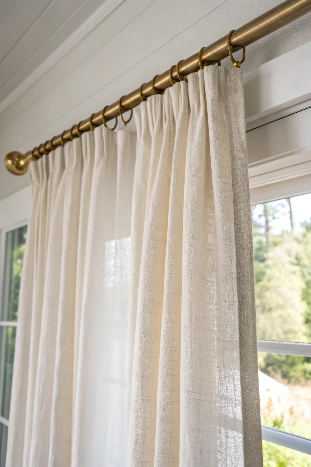 Hang curtains high and wide to make a small bedroom feel taller, brighter, and calmer.