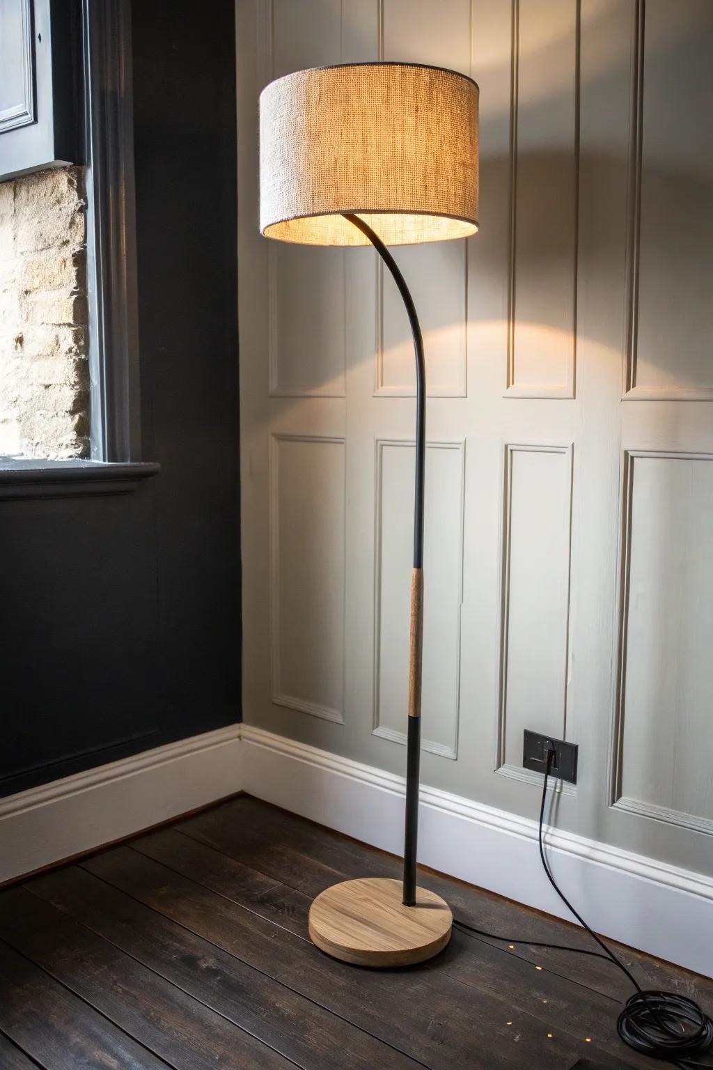 Warm bulbs + a sculptural lamp make black rooms glow—cozy light without harsh overheads.