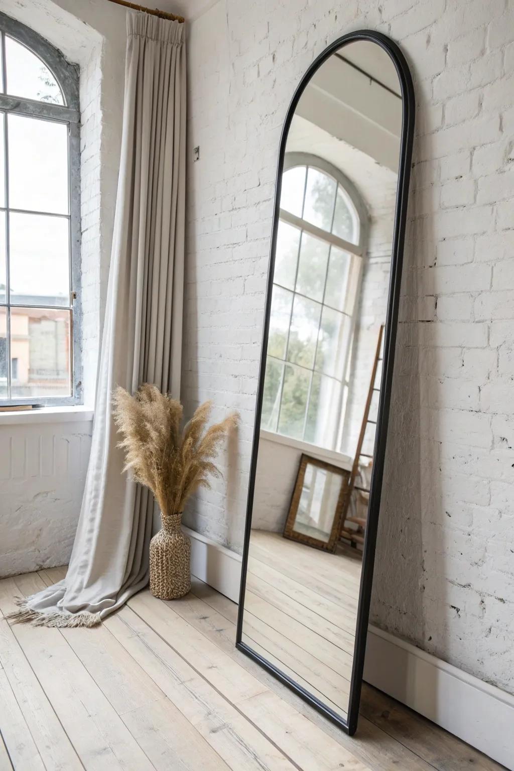 Bounce daylight through a narrow bedroom by leaning a big mirror opposite the window.