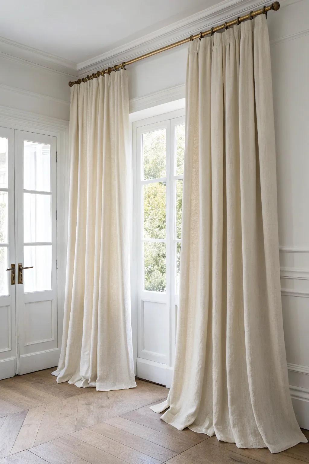 Hang drapes high and wide—floor-to-ceiling linen instantly makes small rooms feel grand.